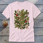 Light pink t-shirt with a central botanical print of evergreen branches, pinecones, holly, and berries.