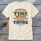 Cream t-shirt with "MOUNTAIN TIME MEANS WHENEVER WE GET THERE" text and a clock icon.