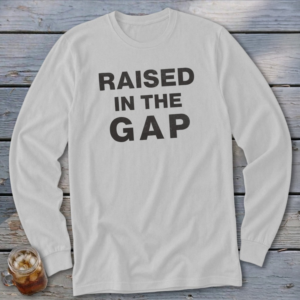 White long-sleeve shirt with "RAISED IN THE GAP" printed in black text.