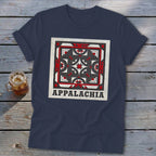 Dark blue t-shirt featuring a square geometric quilt pattern and the text Appalachia laid on wooden planks.