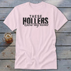 Pink t-shirt with black text "THESE HOLLERS know my name".