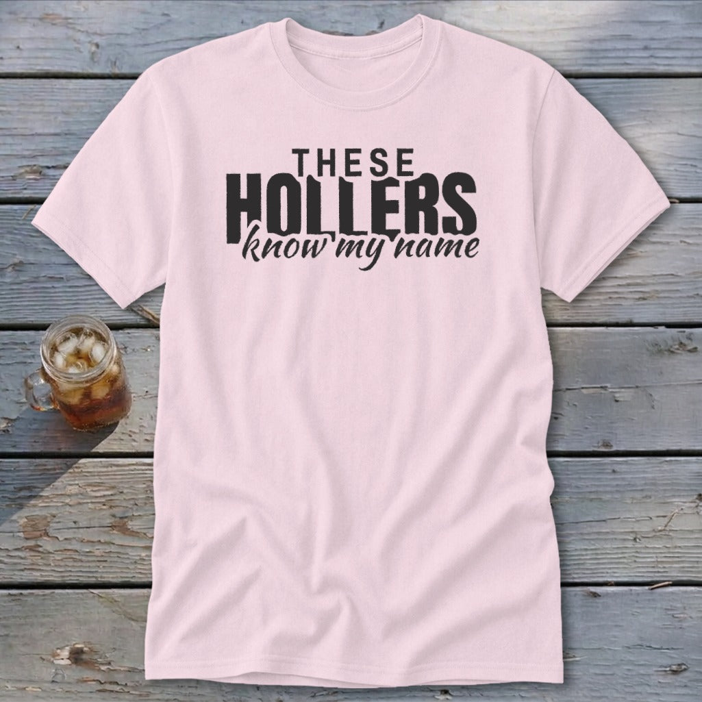 Pink t-shirt with black text "THESE HOLLERS know my name".