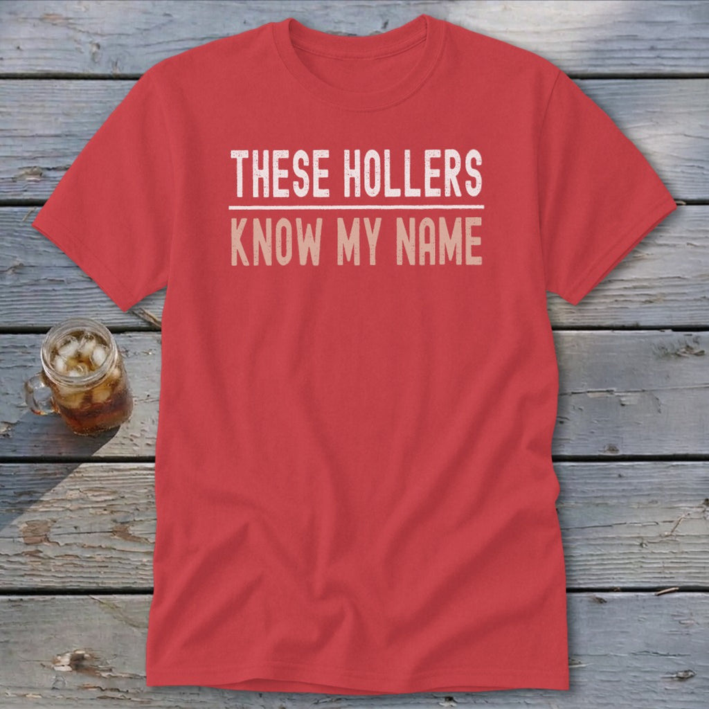 Red t-shirt with "THESE HOLLERS KNOW MY NAME" text.