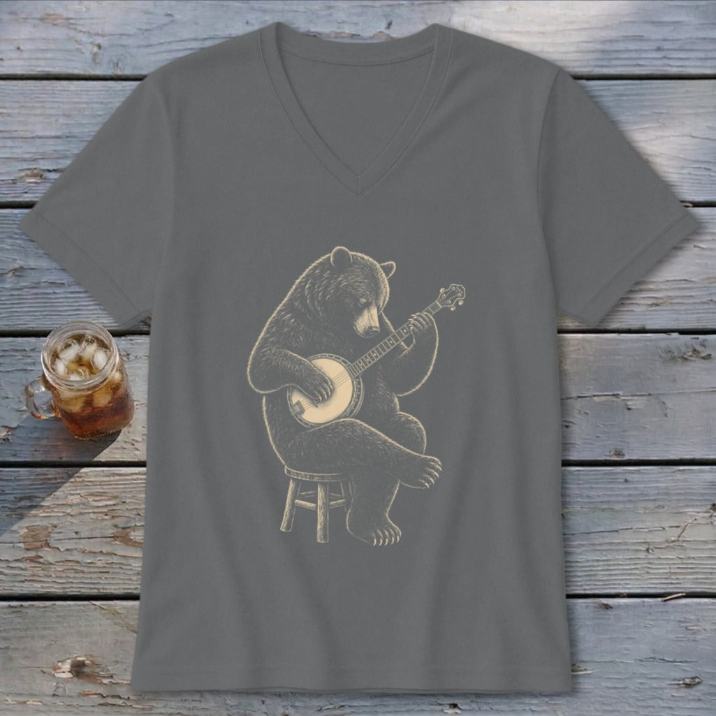 Bear playing a banjo while sitting on a stool.
