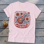 Light pink t-shirt featuring a folk-art acoustic guitar graphic with sunflowers and the text Mountain Melodies.