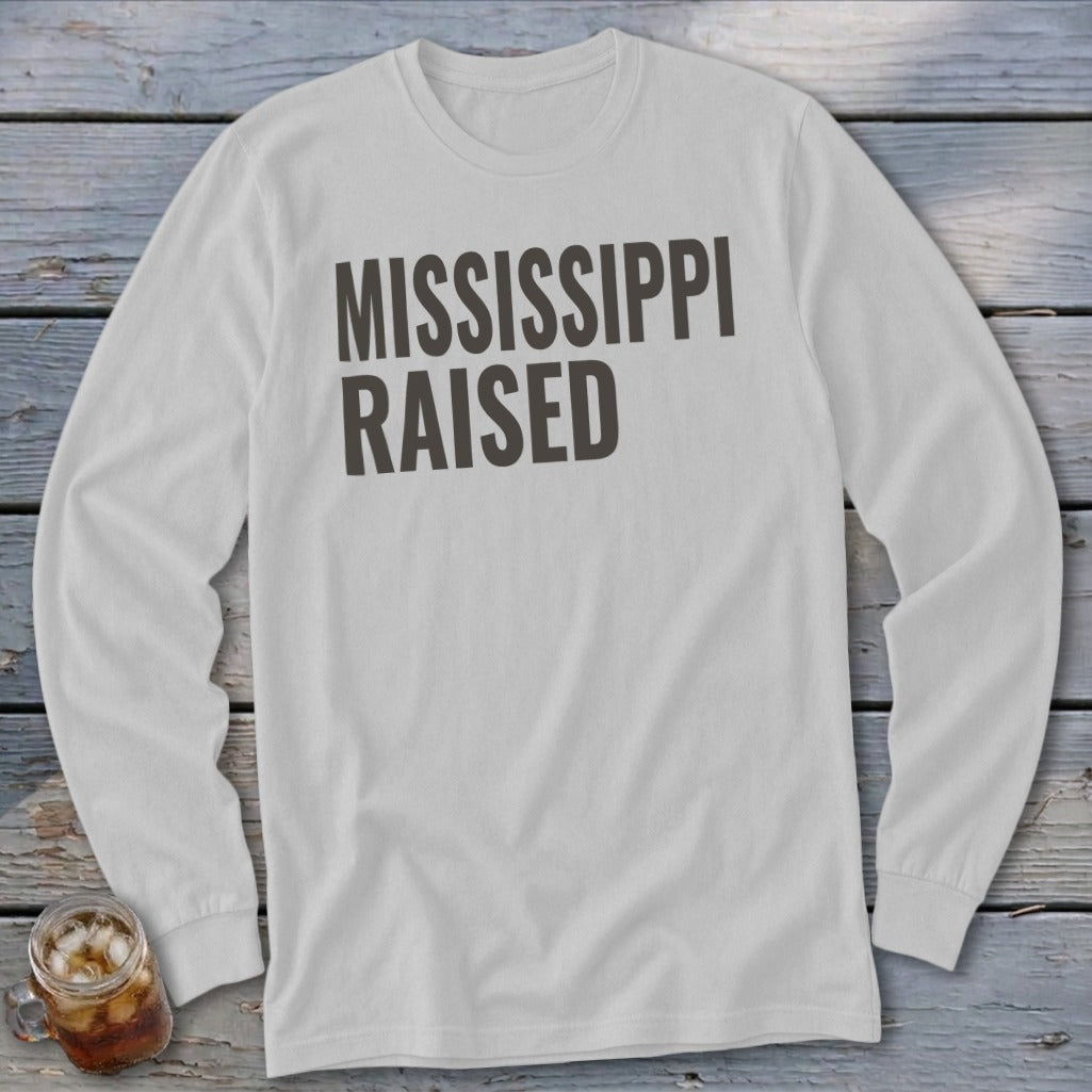 White long-sleeve shirt with "MISSISSIPPI RAISED" text in dark gray.