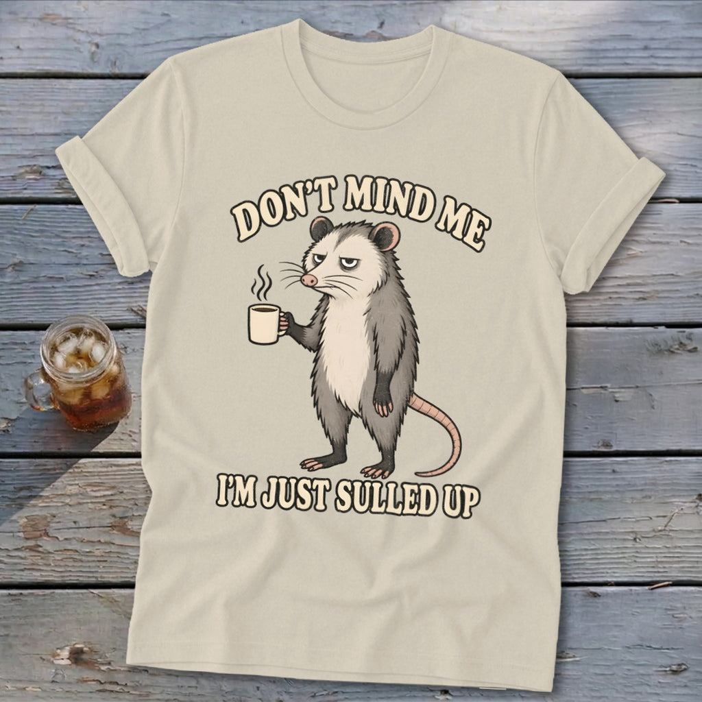 Opossum with coffee mug, text "Don't mind me I'm just sulled up".