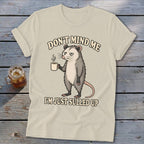 Opossum with coffee mug, text "Don't mind me I'm just sulled up".