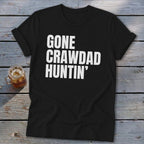 Black t-shirt with white text "GONE CRAWDAD HUNTIN'" and a glass of iced tea.