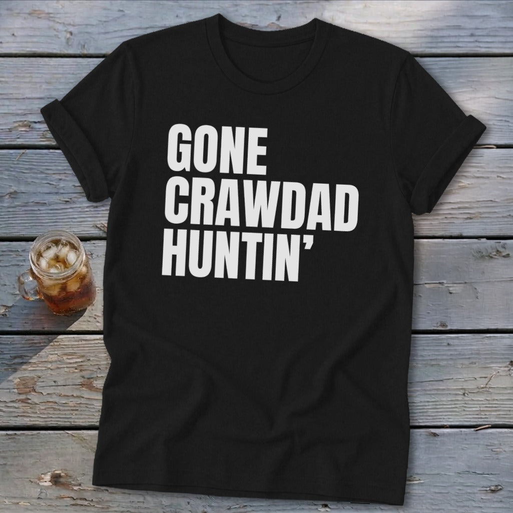 Black t-shirt with white text "GONE CRAWDAD HUNTIN'" and a glass of iced tea.