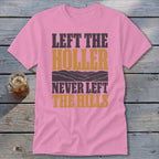 Pink t-shirt with text "LEFT THE HOLLER NEVER LEFT THE HILLS" and hills graphic.