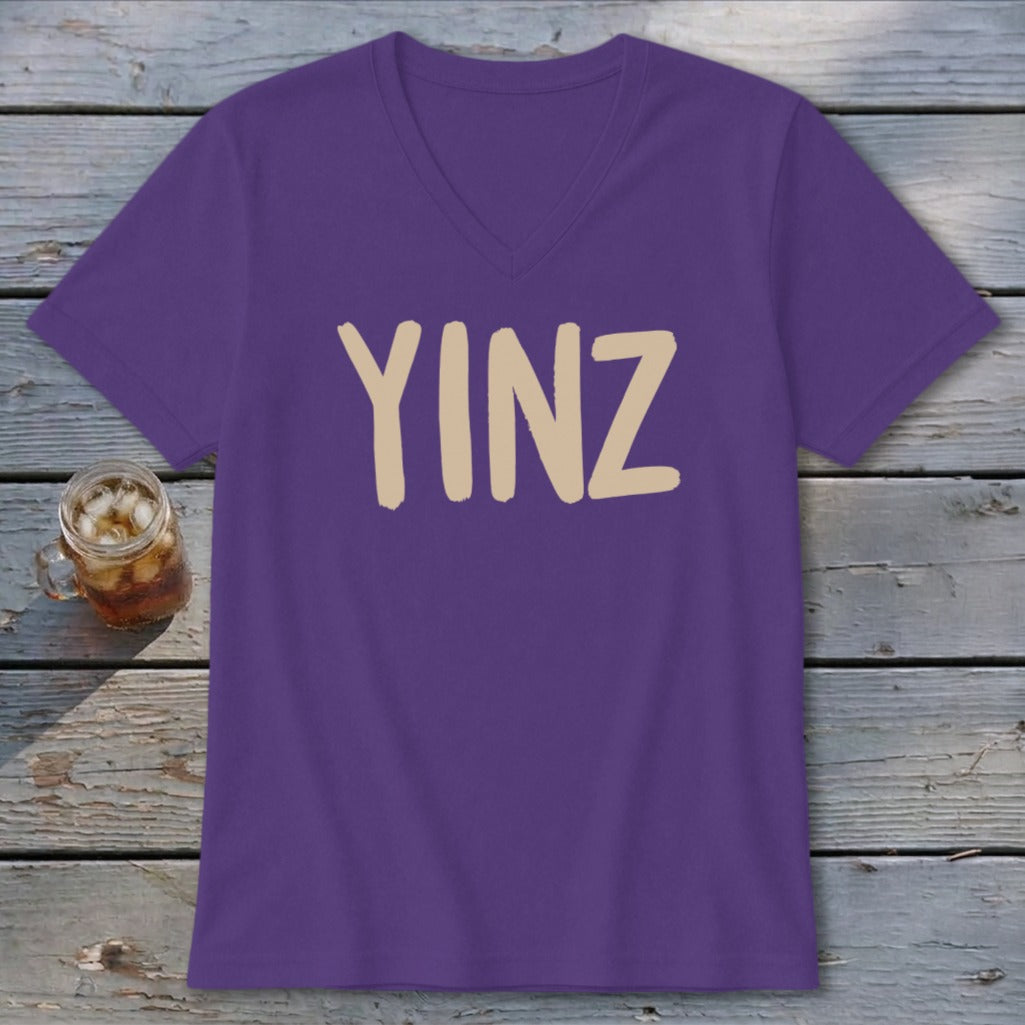 Purple v-neck t-shirt with beige "YINZ" text.