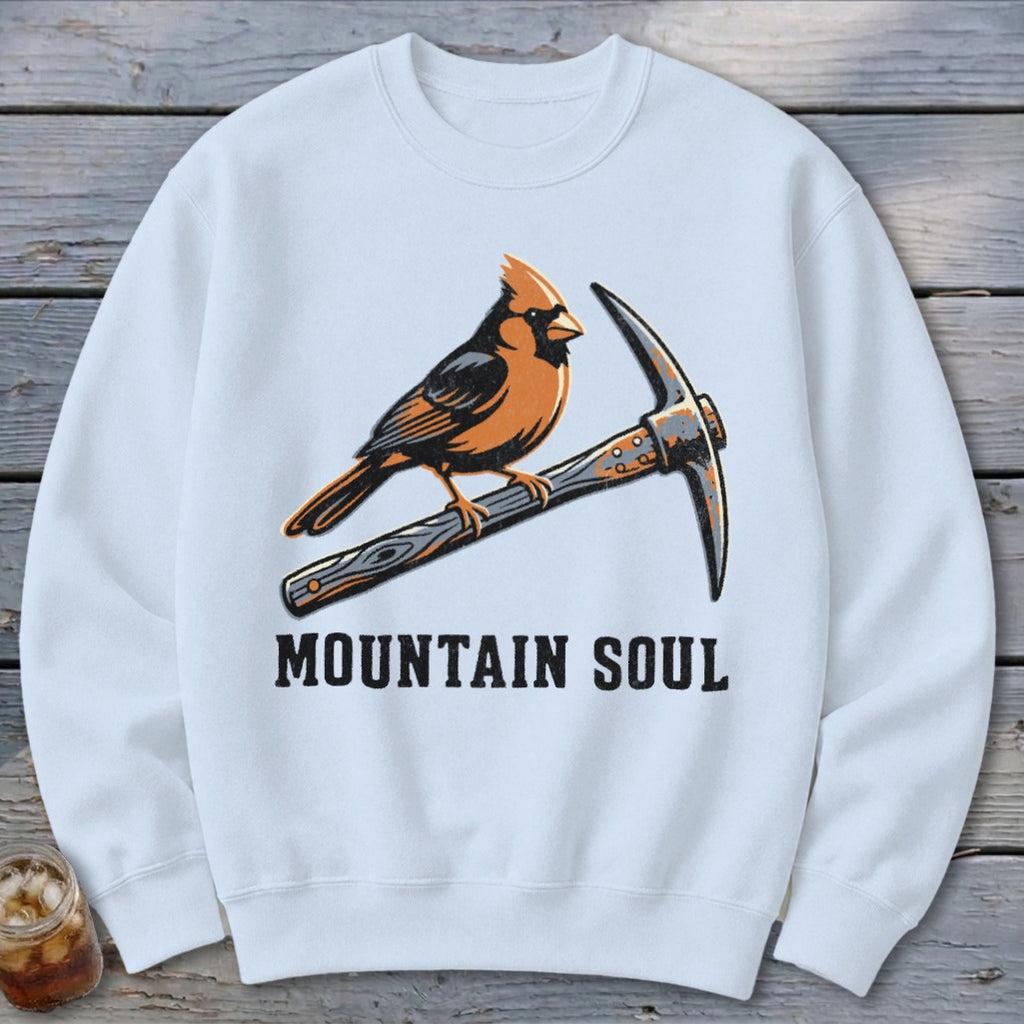 White sweatshirt with cardinal perched on a pickaxe, text "MOUNTAIN SOUL".