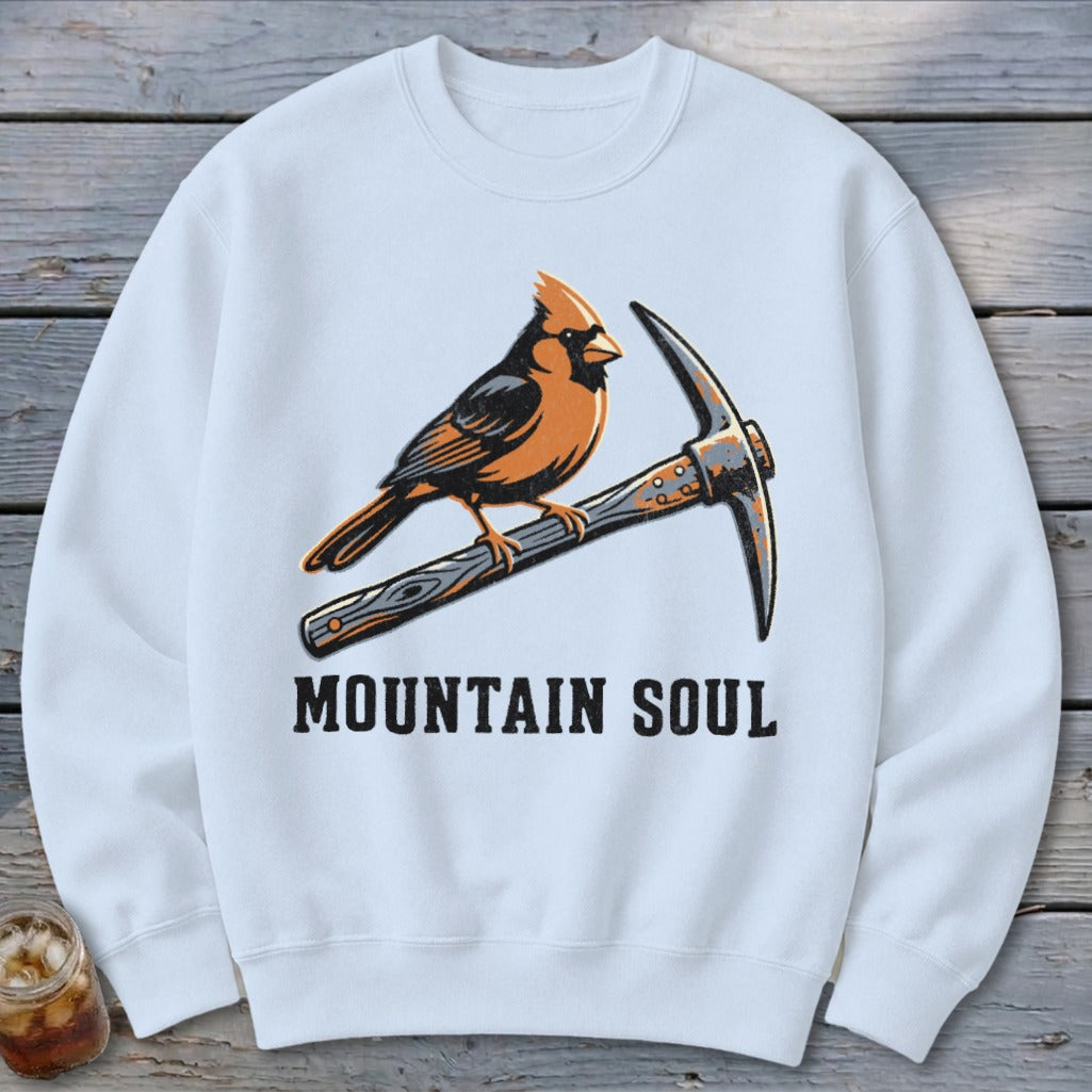 White sweatshirt with cardinal perched on a pickaxe, text "MOUNTAIN SOUL".