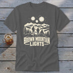 A charcoal gray t-shirt featuring a mountain graphic and the text Brown Mountain Lights.