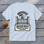 A light blue t-shirt printed with a graphic of a wooden porch, a Wi-Fi signal made of logs, and the text HOLLER WIFI? One bar, if you stand on the porch.