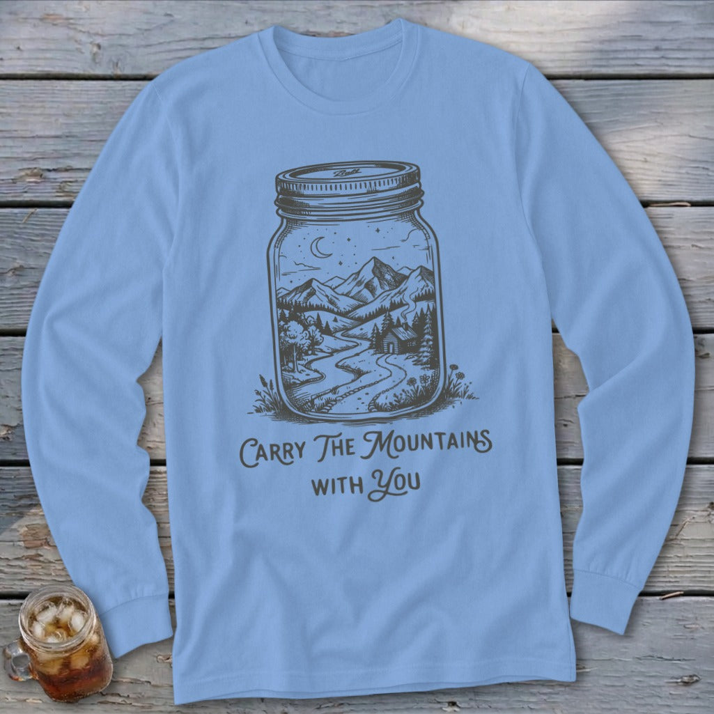 Light blue long-sleeve t-shirt with a graphic of a mountain landscape inside a mason jar and text reading Carry The Mountains With You.