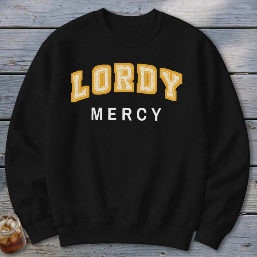 Black sweatshirt with "LORDY MERCY" text in yellow and white lettering.