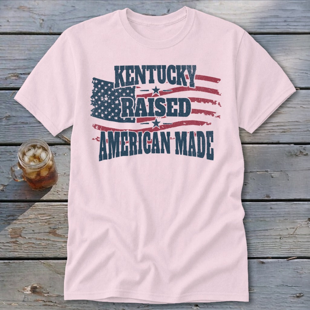 Pink t-shirt with distressed American flag graphic and text "Kentucky Raised American Made".