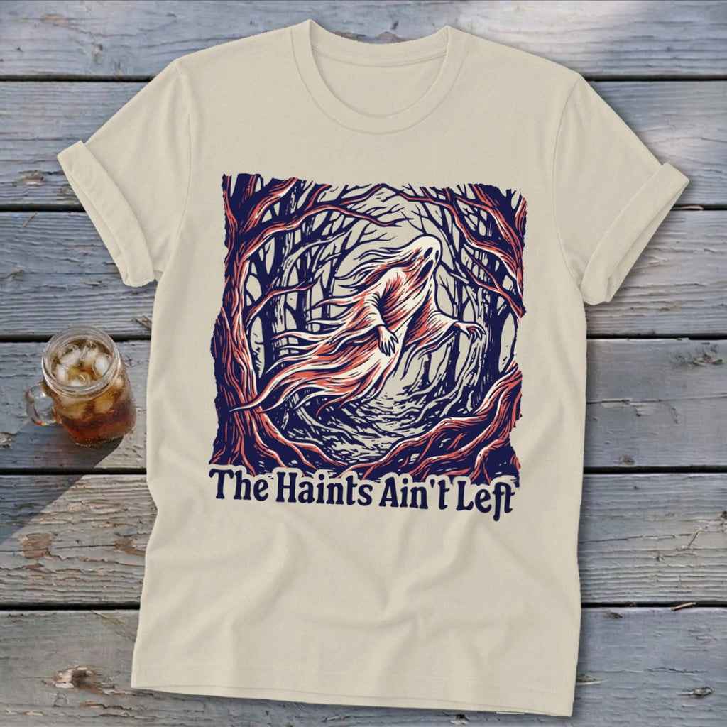 Cream t-shirt with a ghostly figure and trees design that reads "The Haints Ain't Left".