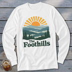 White long-sleeve shirt with "The Foothills" text and a mountain landscape graphic.