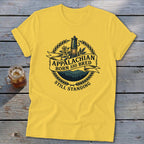 Yellow t-shirt with "Appalachian Born and Bred Still Standing" text and an oil lamp graphic.