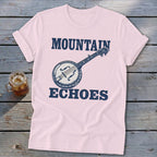 A light pink t-shirt with blue text reading Mountain Echoes and a banjo graphic.