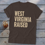 Brown t-shirt with "WEST VIRGINIA RAISED" in large, tan text.