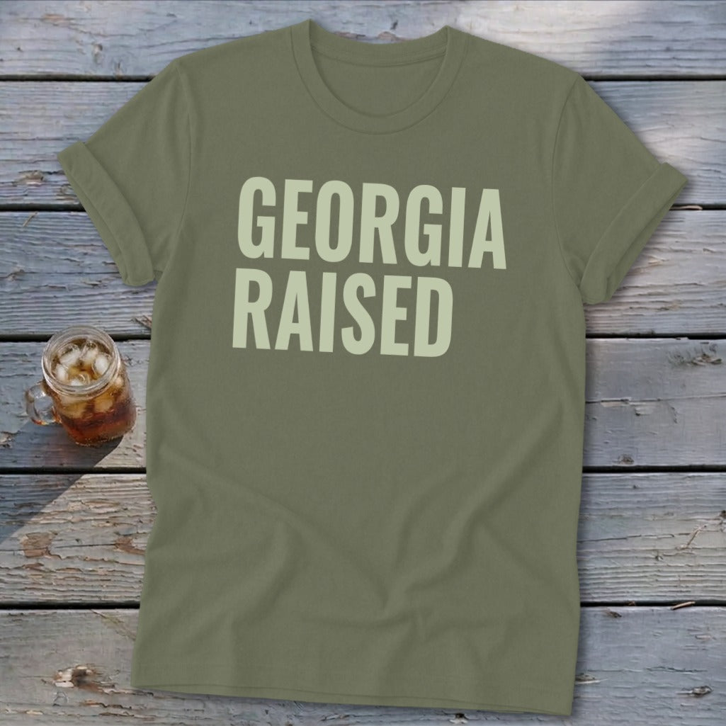 Olive green t-shirt with "GEORGIA RAISED" text in light green.