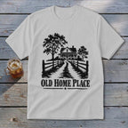 White t-shirt with black graphic of a house, trees, fence, and text "OLD HOME PLACE".