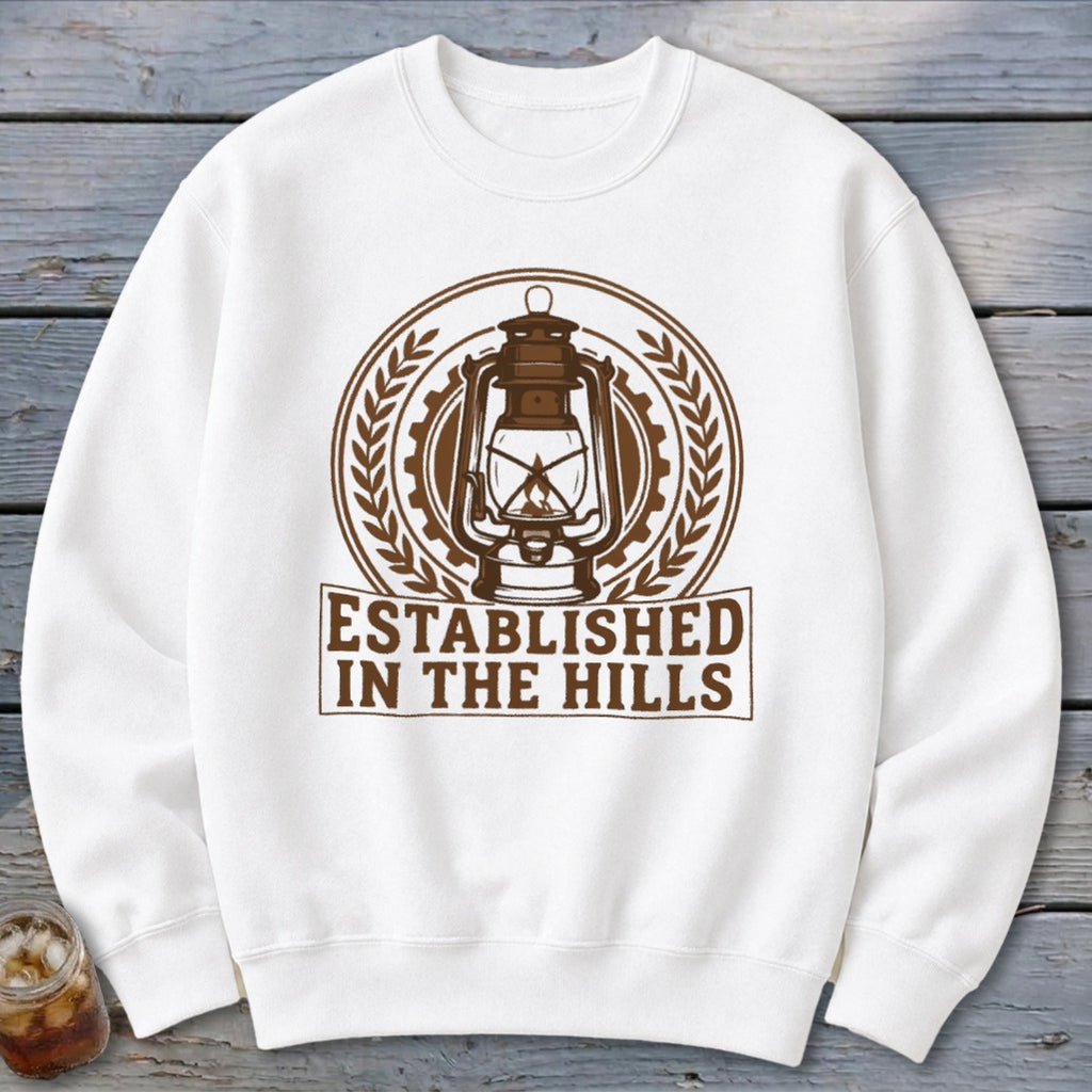 White sweatshirt with "Established in the Hills" text and a vintage lantern graphic.