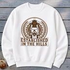 White sweatshirt with "Established in the Hills" text and a vintage lantern graphic.