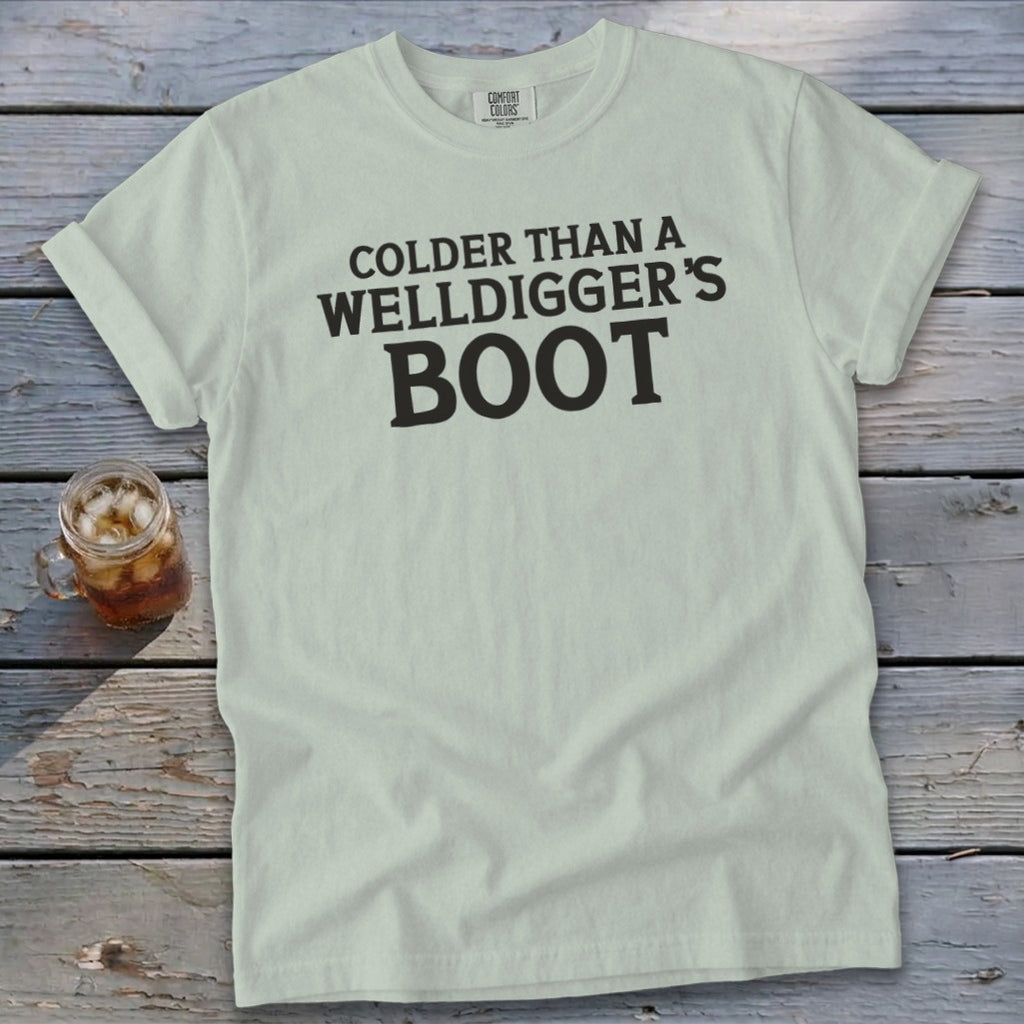 Light blue t-shirt with black text that reads "Colder Than a Welldigger's Boot".