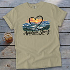 Tan t-shirt with "Appalachia Strong" text and heart-shaped mountain sunset graphic.
