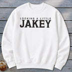 White crewneck sweatshirt with black text "LOOKING A LITTLE JAKEY"
