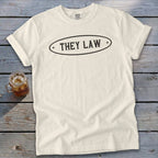 Cream t-shirt with black oval graphic saying "THEY LAW".