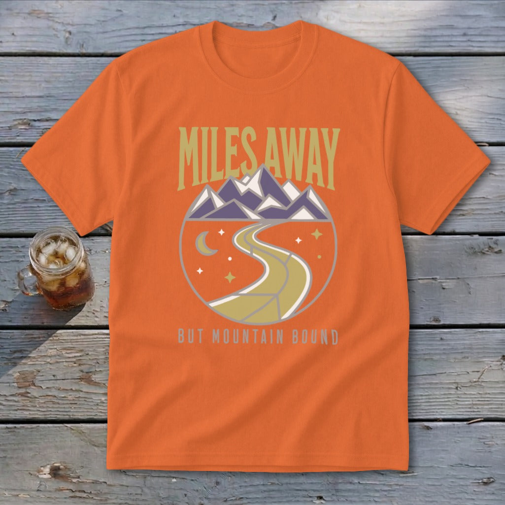 Orange t-shirt with "Miles Away But Mountain Bound" text and circular mountain road graphic.