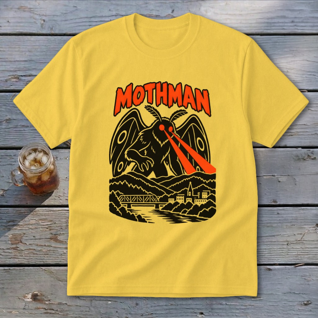Yellow t-shirt with Mothman illustration and text above a town and bridge.