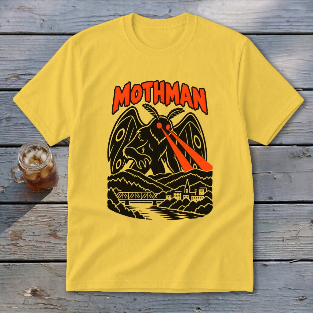 Yellow t-shirt with Mothman illustration and text above a town and bridge.