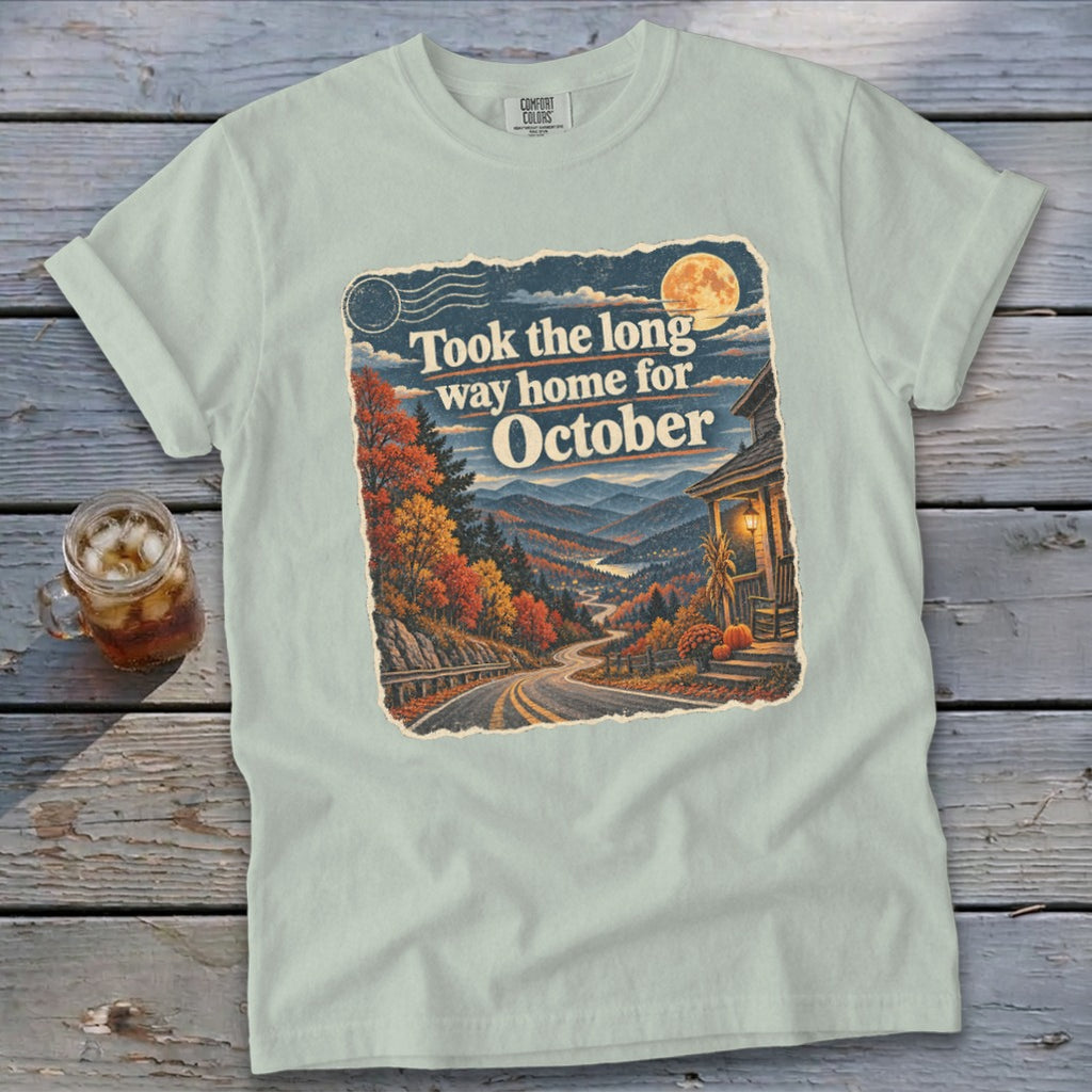 T-shirt with "Took the long way home for October" graphic featuring a scenic mountain road.