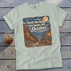 T-shirt with "Took the long way home for October" graphic featuring a scenic mountain road.