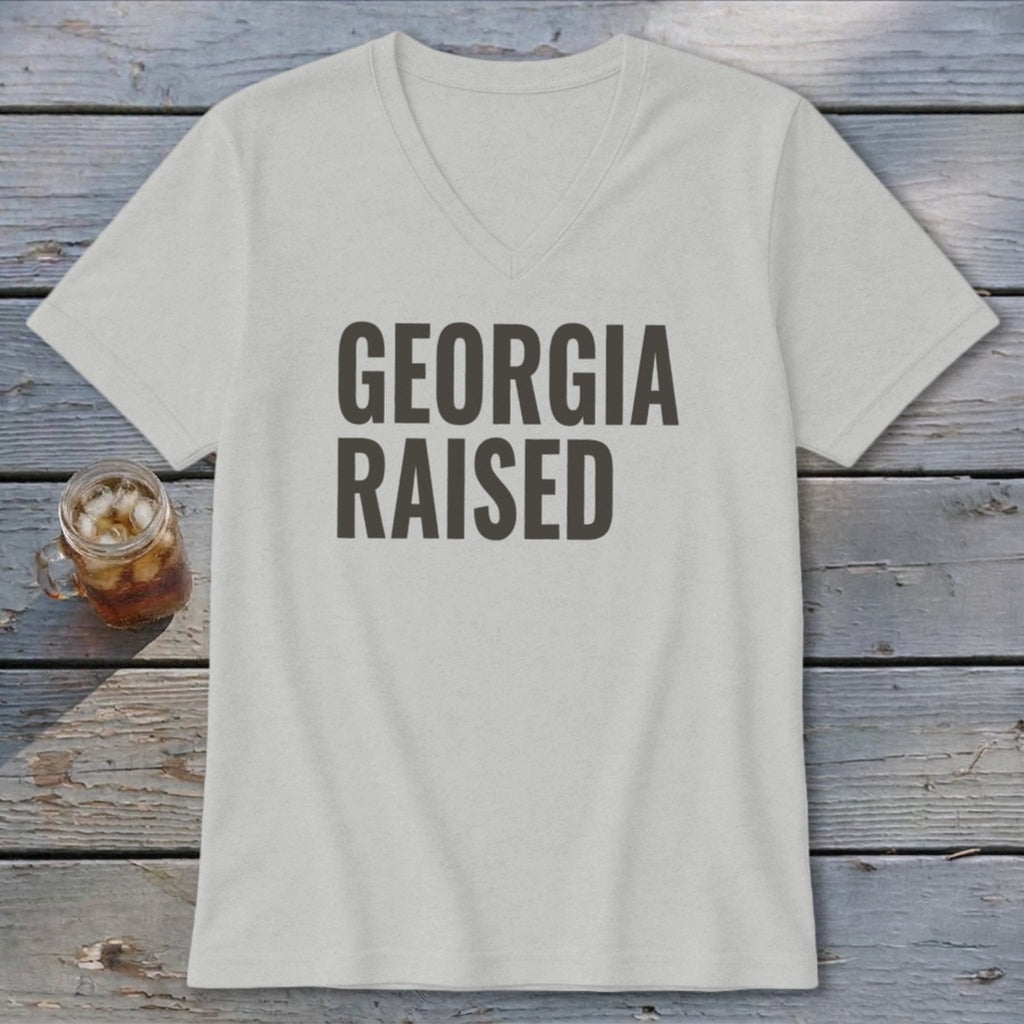 Light grey v-neck t-shirt with "GEORGIA RAISED" text.