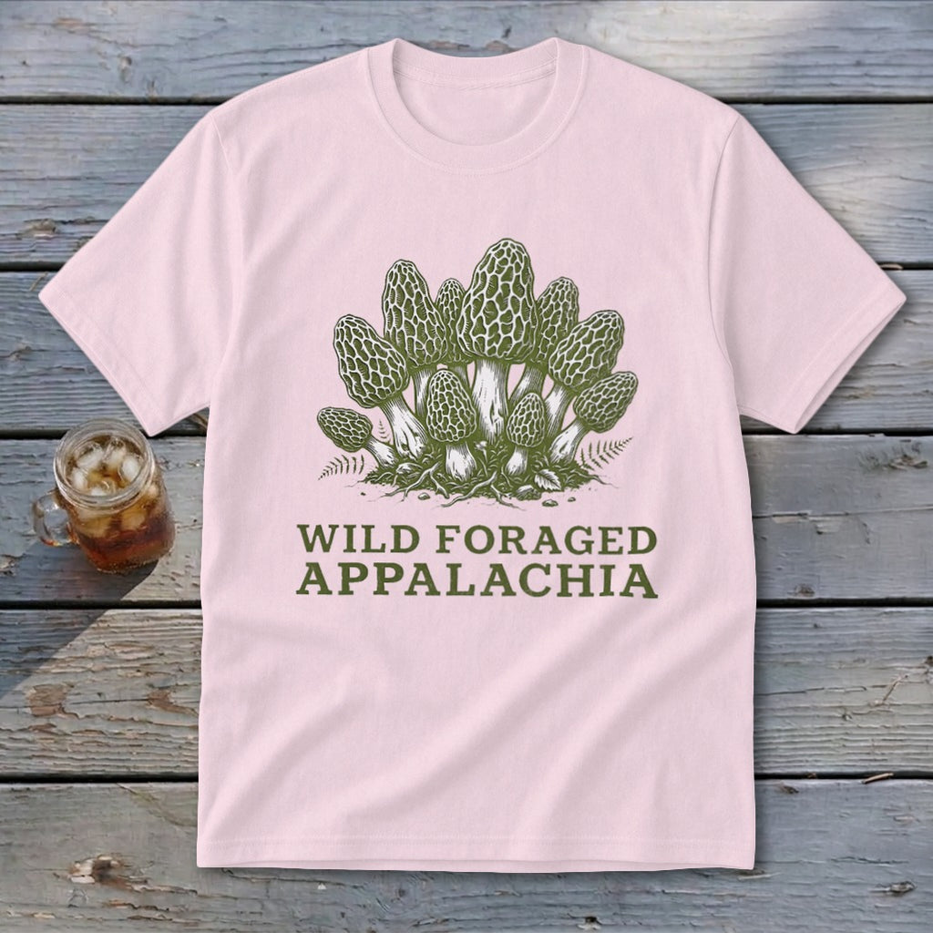 Pink t-shirt with a green graphic of morel mushrooms and text "Wild Foraged Appalachia".