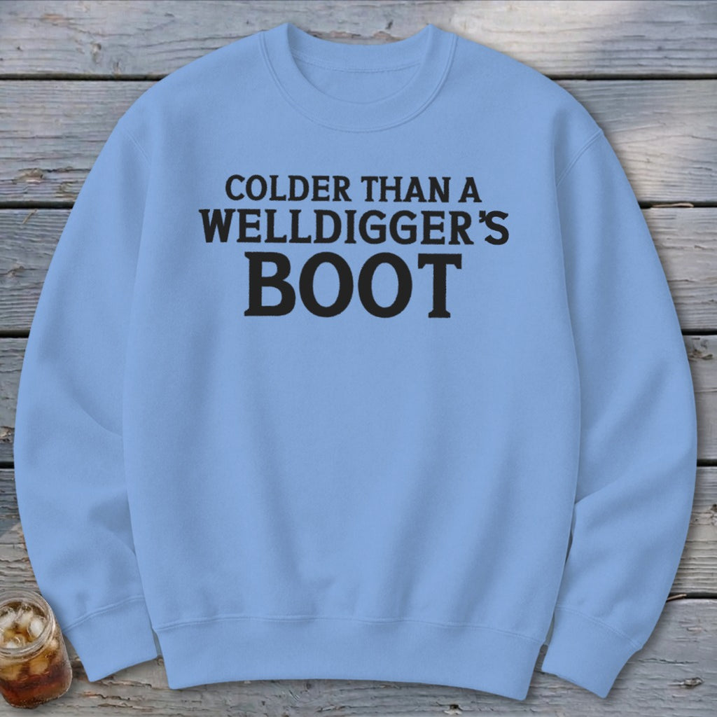 Light blue crewneck sweatshirt with black text "Colder than a Welldigger's Boot".