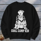 Black sweatshirt with white graphic of a boy in overalls and cap holding a bucket, text reads "COAL CAMP KID".