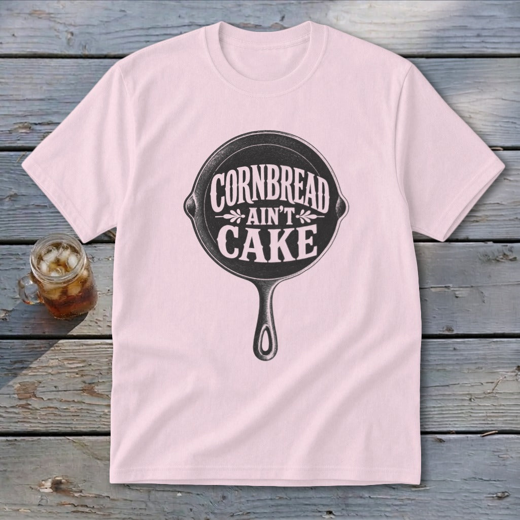 Pink t-shirt with "Cornbread Ain't Cake" text inside a cast iron skillet graphic.