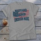 Gray t-shirt with "Maryland Raised American Made" and American flag graphic.