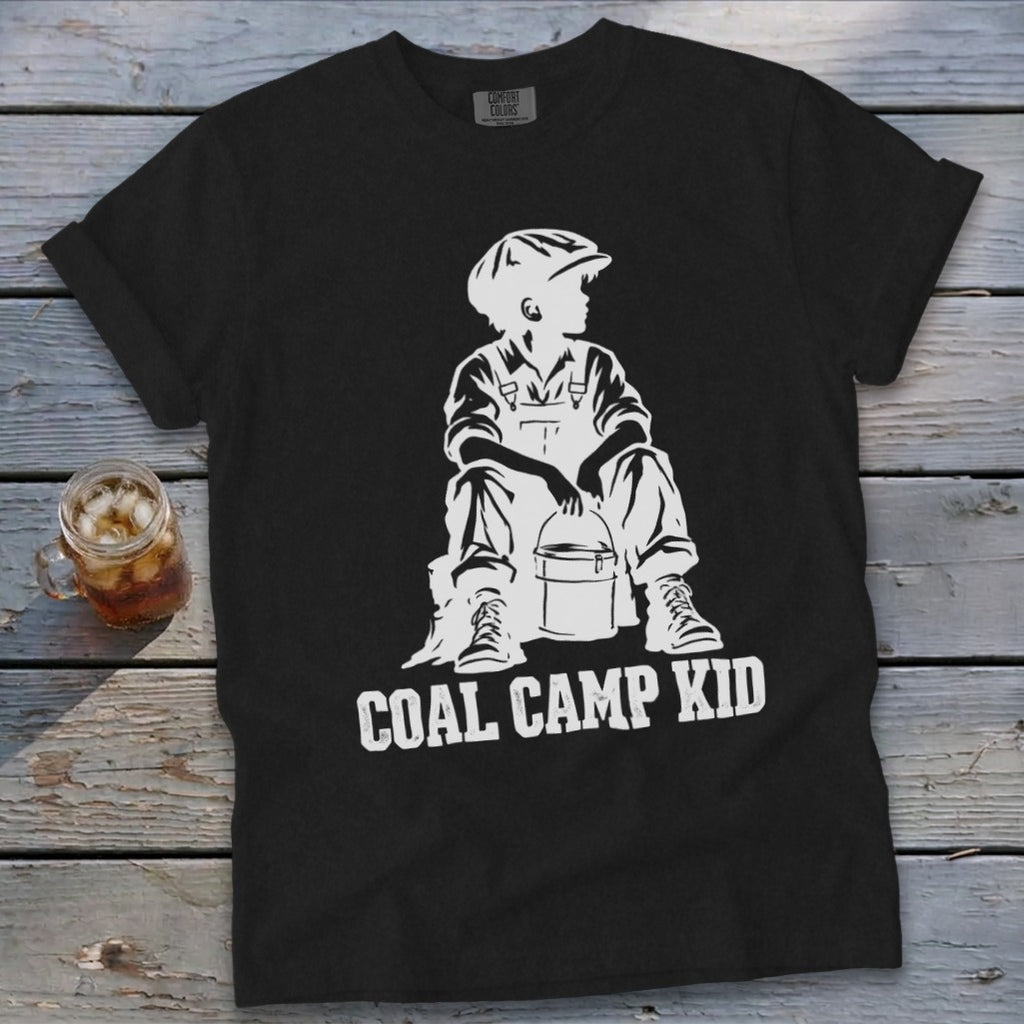 Black t-shirt with white graphic of a boy holding a bucket, with text "COAL CAMP KID".