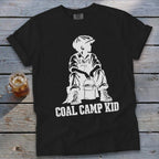 Black t-shirt with white graphic of a boy holding a bucket, with text "COAL CAMP KID".