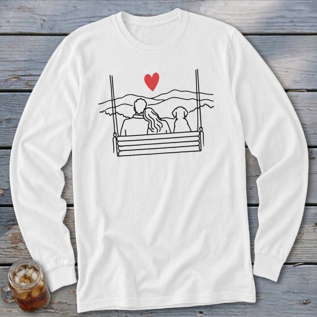 Couple and dog on a swing with mountains and a red heart above.